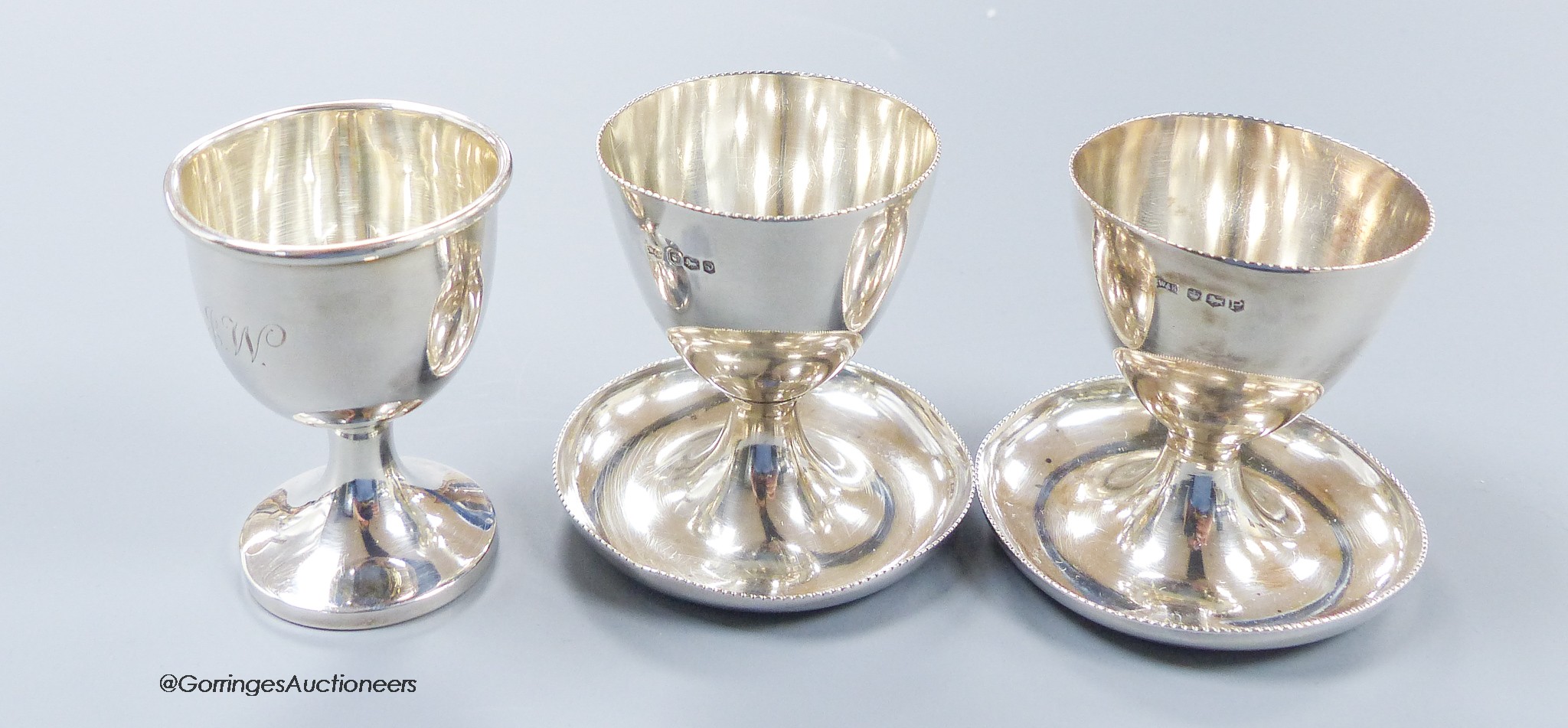 A pair of 1950's silver egg cups, Walker & Hall, Sheffield, 1957/8, 55mm and one other silver egg cup, 131 grams.
